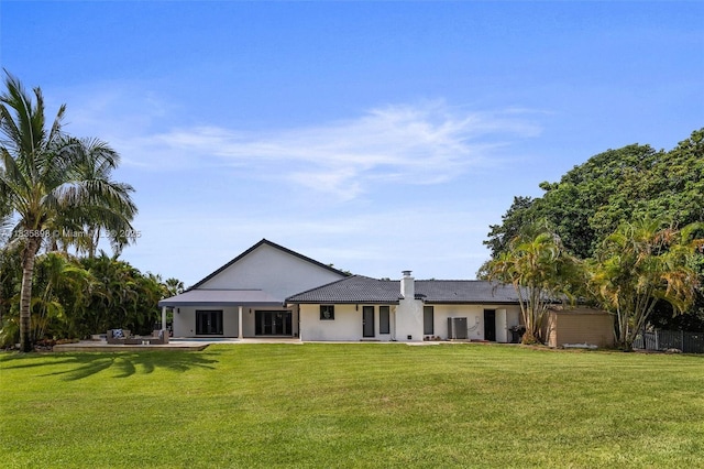 11965 SW 15th Ct, Davie, FL 33325 - rear view of property featuring a lawn, stucco siding, and a tile roof