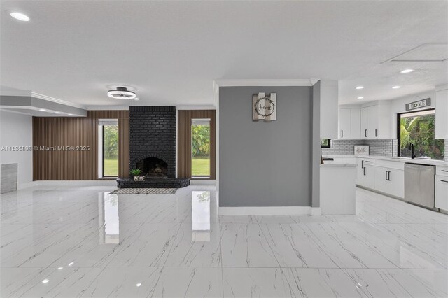 11965 SW 15th Ct, Davie, FL 33325 - unfurnished living room featuring light marble finish floors, ornamental molding, healthy amount of natural light, a fireplace, and recessed lighting