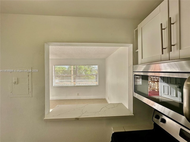 241 SE 9th Ave Unit 207, Pompano Beach, FL 33060 - kitchen view of electric range oven, stainless steel microwave, and light countertops