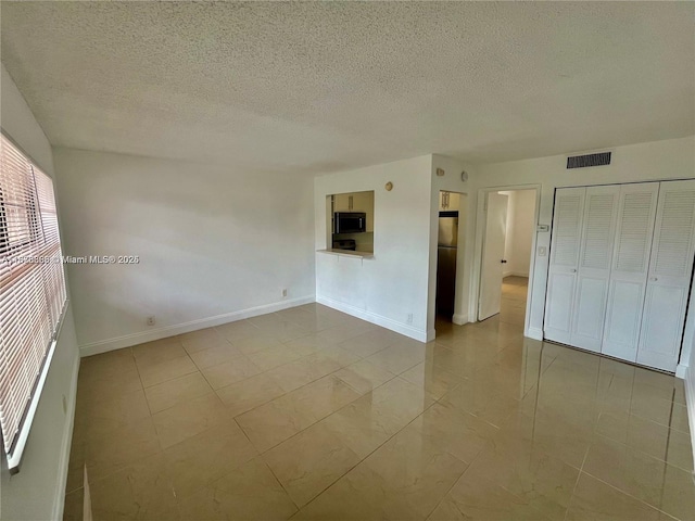 241 SE 9th Ave Unit 207, Pompano Beach, FL 33060 - unfurnished room with a textured ceiling