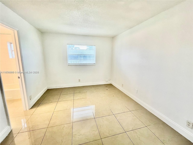 241 SE 9th Ave Unit 207, Pompano Beach, FL 33060 - empty room with a textured ceiling and light tile patterned floors