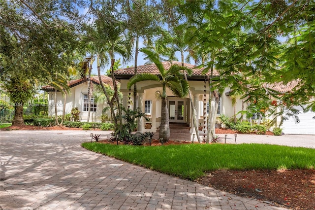 12530 SW 96th Ct, Miami, FL 33176 - mediterranean / spanish home featuring french doors, stucco siding, decorative driveway, and a tile roof