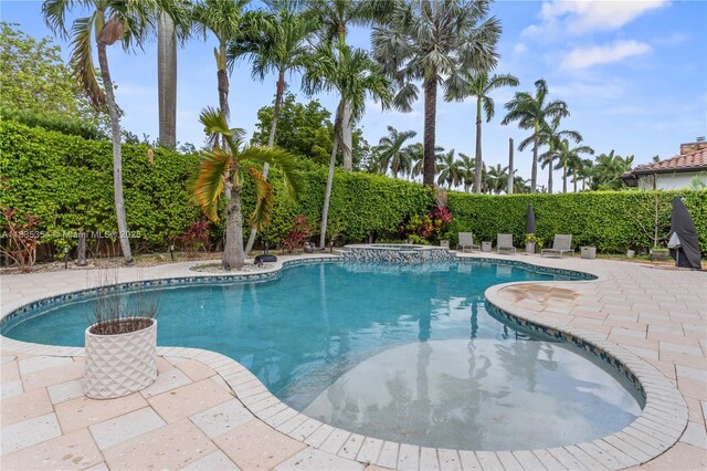 12530 SW 96th Ct, Miami, FL 33176 - view of swimming pool with a pool with connected hot tub, a patio area, and a fenced backyard