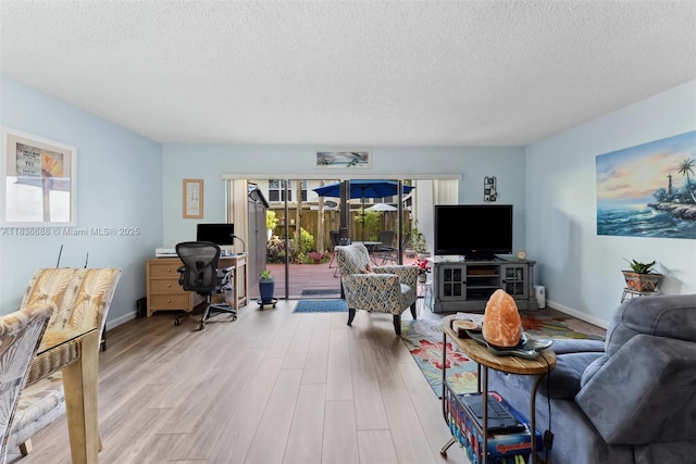 3300 Atlanta St, Hollywood, FL 33021 - living room with plenty of natural light, a textured ceiling, wood finished floors, and a desk