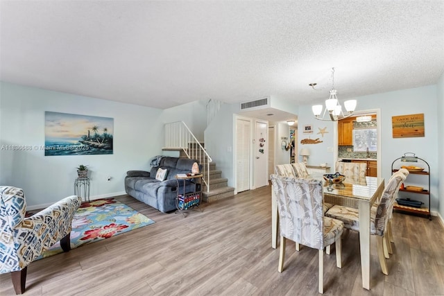 3300 Atlanta St, Hollywood, FL 33021 - dining area with a chandelier, stairway, wood finished floors, and a textured ceiling