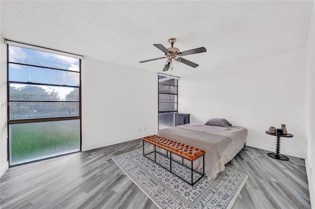 3401 N Country Club Dr Unit 308, Aventura, FL 33180 - bedroom featuring multiple windows, wood finished floors, and ceiling fan