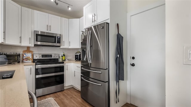 15107 NW 8th St, Pembroke Pines, FL 33028 - kitchen with stainless steel appliances, decorative backsplash, and white cabinetry