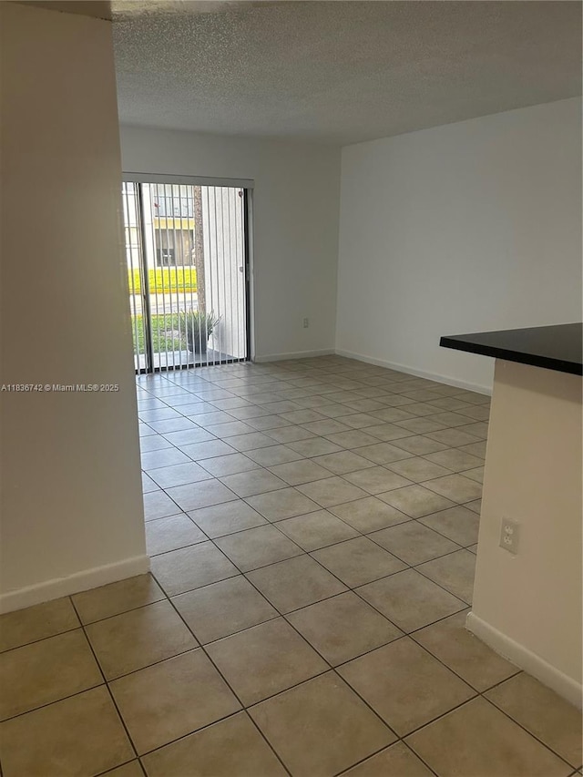 7110 NW 179th St Unit 110, Hialeah, FL 33015 - unfurnished room with light tile patterned floors and a textured ceiling
