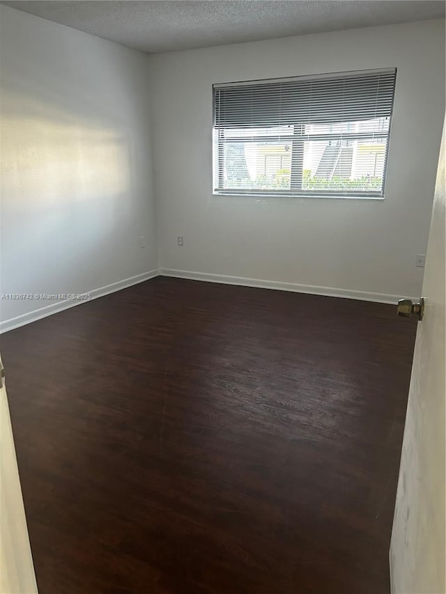 7110 NW 179th St Unit 110, Hialeah, FL 33015 - spare room with healthy amount of natural light and dark wood-style flooring
