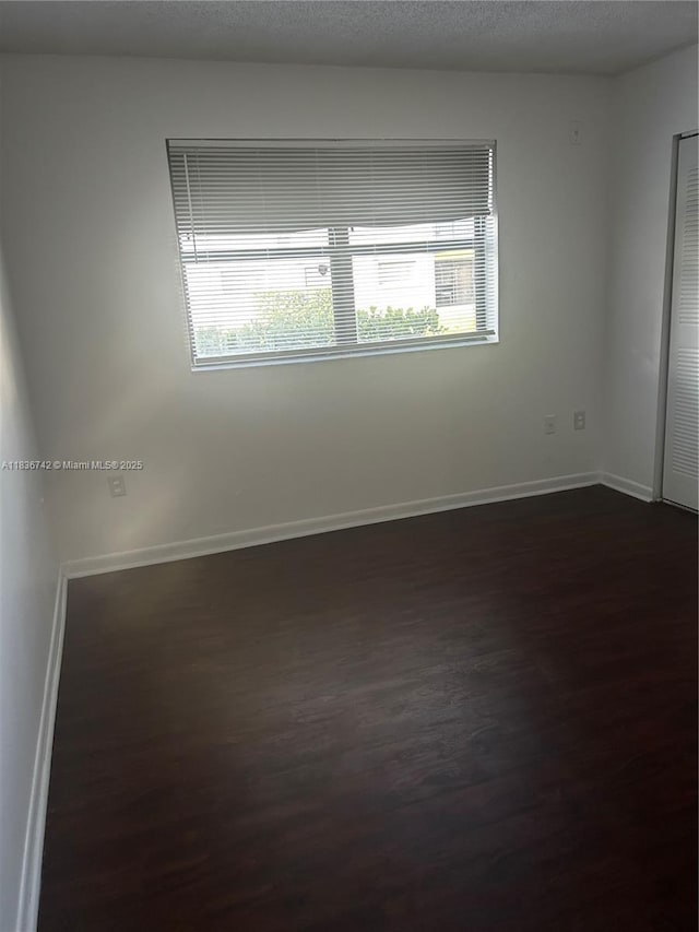 7110 NW 179th St Unit 110, Hialeah, FL 33015 - unfurnished room with dark wood-type flooring and baseboards