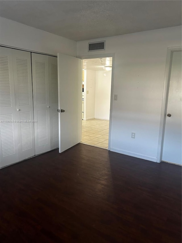 7110 NW 179th St Unit 110, Hialeah, FL 33015 - unfurnished bedroom featuring wood finished floors and a closet