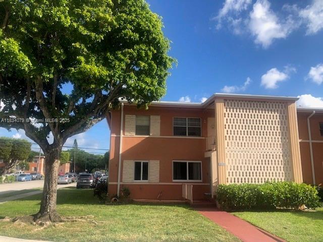 3600 SW 9th Ter Unit 1B, Miami, FL 33135 - rear view of property with a lawn and stucco siding