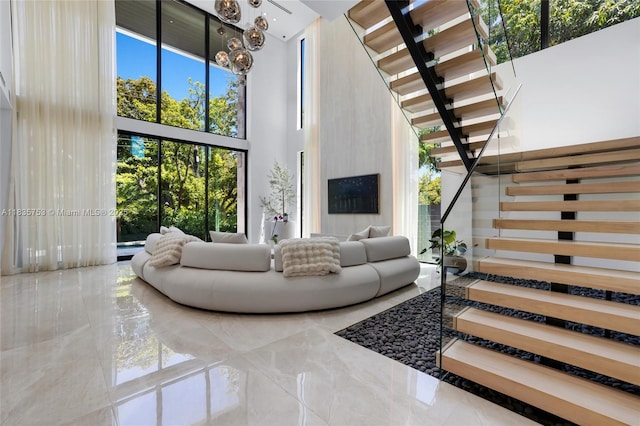 1351 SW 16th St, Miami, FL 33145 - living area with stairs, a high ceiling, and marble tiled floors