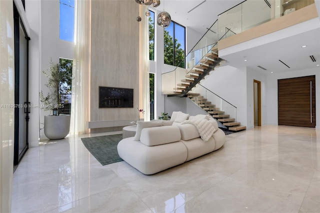 1351 SW 16th St, Miami, FL 33145 - living area featuring a towering ceiling, stairway, and light marble finish floors