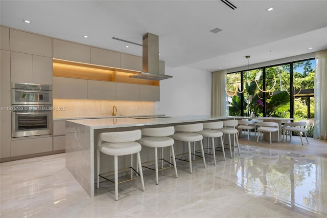 1351 SW 16th St, Miami, FL 33145 - kitchen with modern cabinets, island exhaust hood, tasteful backsplash, double oven, and light marble finish flooring