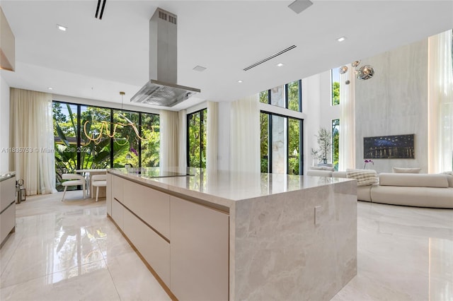 1351 SW 16th St, Miami, FL 33145 - kitchen featuring island range hood, modern cabinets, light marble finish floors, and recessed lighting