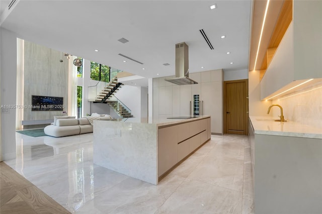 1351 SW 16th St, Miami, FL 33145 - kitchen featuring range hood, modern cabinets, black electric cooktop, light marble finish floors, and light stone counters