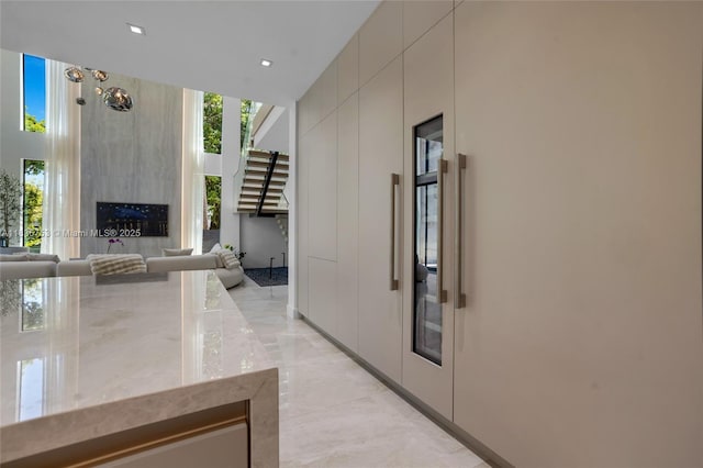 1351 SW 16th St, Miami, FL 33145 - interior space with light marble finish flooring, a large fireplace, light stone countertops, recessed lighting, and open floor plan