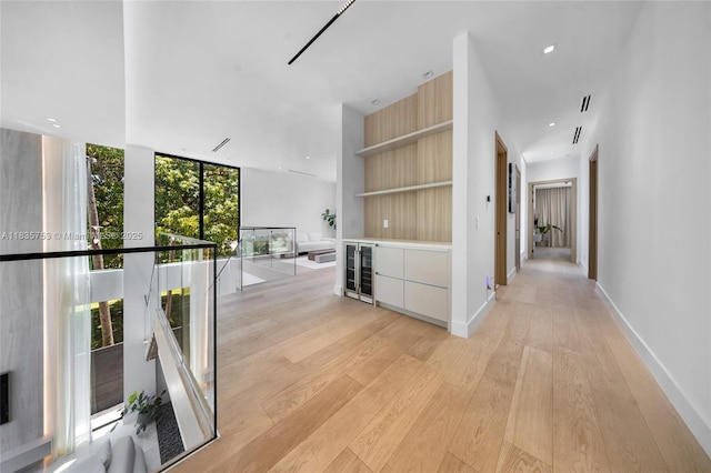 1351 SW 16th St, Miami, FL 33145 - corridor featuring light wood-style floors, recessed lighting, wine cooler, and floor to ceiling windows