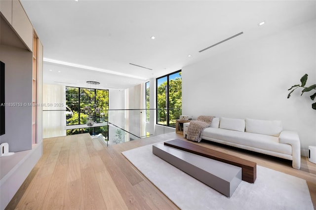 1351 SW 16th St, Miami, FL 33145 - living room with expansive windows, light wood-style flooring, and recessed lighting