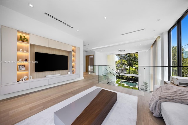 1351 SW 16th St, Miami, FL 33145 - living area featuring floor to ceiling windows, wood finished floors, and plenty of natural light