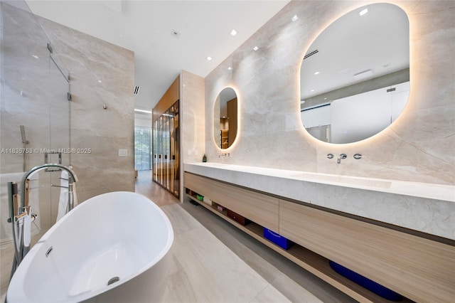 1351 SW 16th St, Miami, FL 33145 - full bathroom with double vanity, a freestanding tub, tile walls, recessed lighting, and a shower with door