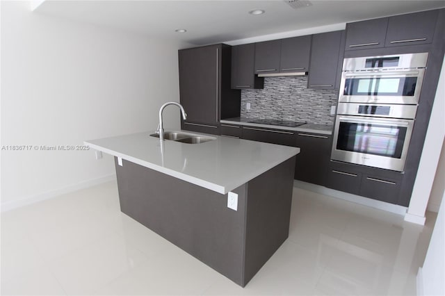 7875 NW 107th Ct Unit 519 4, Doral, FL 33178 - kitchen featuring double oven, black electric stovetop, tasteful backsplash, a center island with sink, and modern cabinets