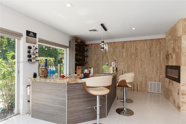 5712 White Hickory Cir, Tamarac, FL 33319 - indoor wet bar featuring tile patterned flooring and wood walls