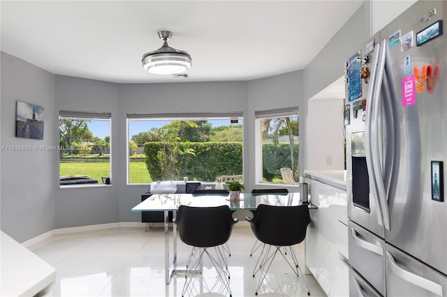 5712 White Hickory Cir, Tamarac, FL 33319 - dining room with light tile patterned floors and baseboards