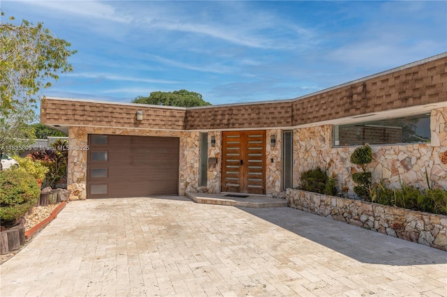 5712 White Hickory Cir, Tamarac, FL 33319 - view of front of property featuring an attached garage, mansard roof, decorative driveway, and stone siding