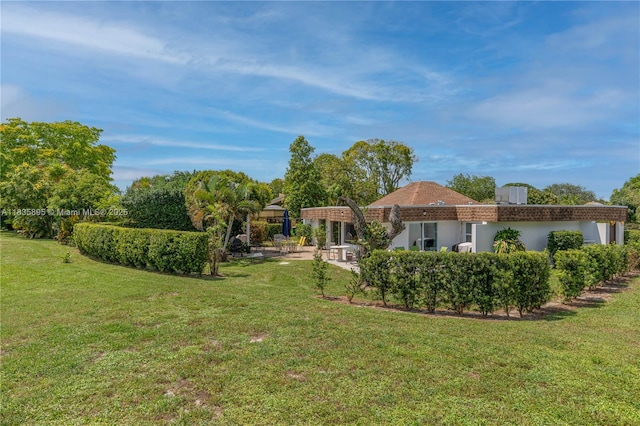 5712 White Hickory Cir, Tamarac, FL 33319 - view of green lawn with a patio area