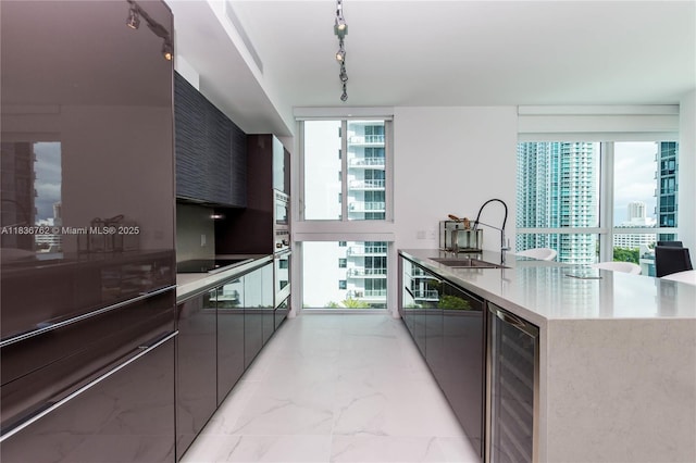 1080 Brickell Ave Unit 1708, Miami, FL 33131 - kitchen with track lighting, modern cabinets, and wine cooler