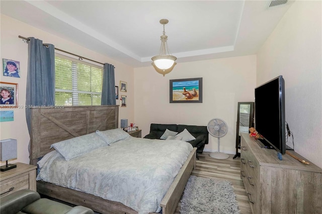 12548 SW 126th Ave, Miami, FL 33186 - bedroom featuring light wood finished floors and a tray ceiling
