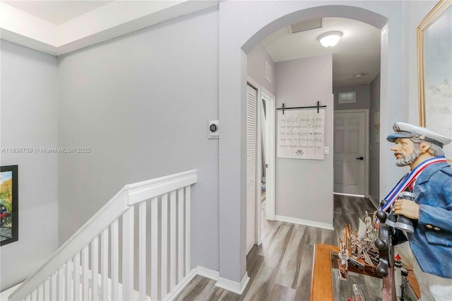 12548 SW 126th Ave, Miami, FL 33186 - corridor with arched walkways, wood finished floors, and an upstairs landing