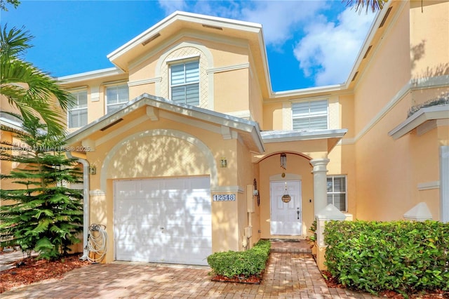 12548 SW 126th Ave, Miami, FL 33186 - view of front of house with stucco siding, an attached garage, and decorative driveway