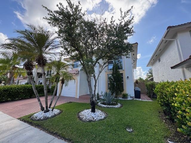 628 Turtle Run, Weston, FL 33326 - mediterranean / spanish house with decorative driveway, a front yard, and stucco siding