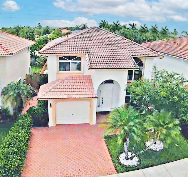 628 Turtle Run, Weston, FL 33326 - mediterranean / spanish-style house with a tile roof, stucco siding, and driveway