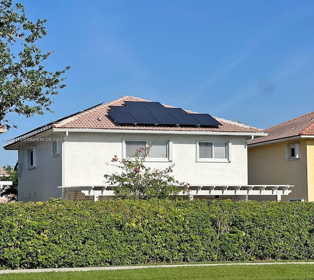 628 Turtle Run, Weston, FL 33326 - view of side of home with stucco siding and roof mounted solar panels