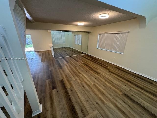 628 Turtle Run, Weston, FL 33326 - unfurnished bedroom with wood finished floors and a textured ceiling