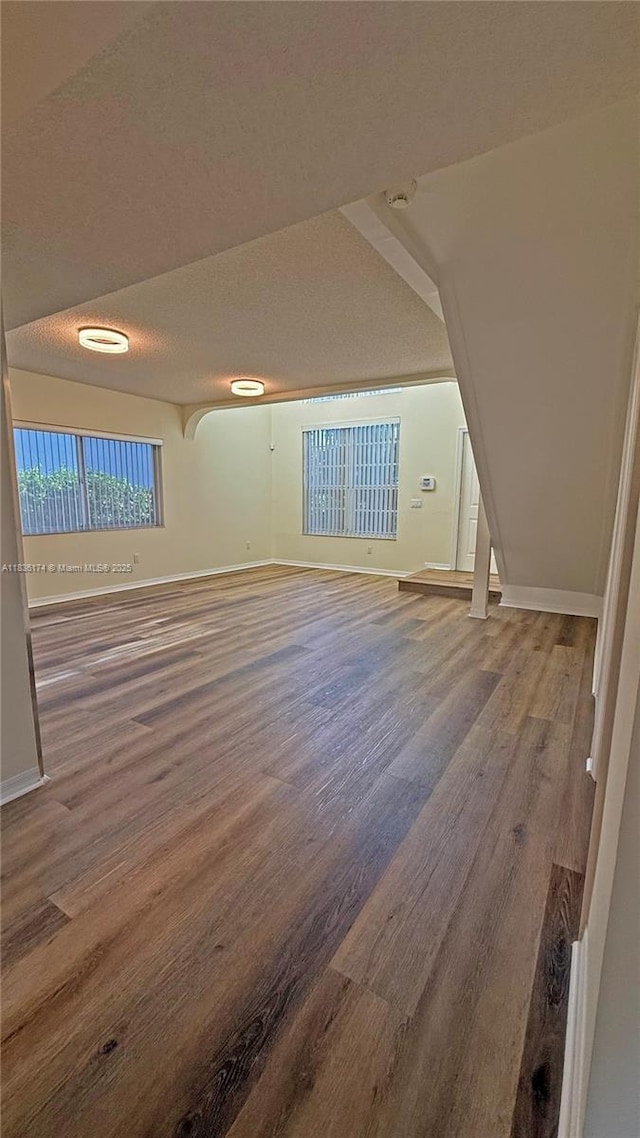 628 Turtle Run, Weston, FL 33326 - unfurnished living room featuring wood finished floors and a textured ceiling