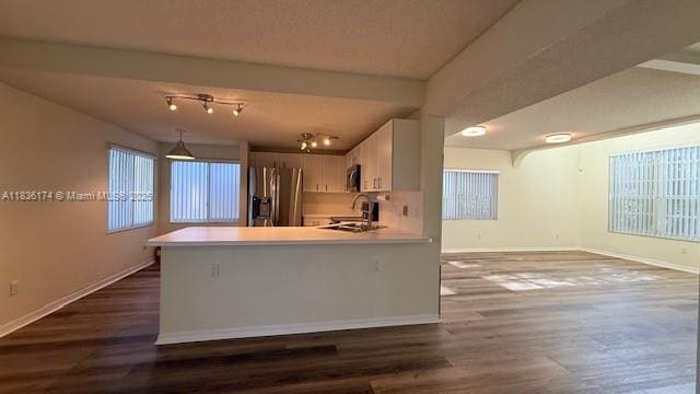 628 Turtle Run, Weston, FL 33326 - kitchen with stainless steel appliances, light countertops, dark wood-type flooring, a peninsula, and white cabinetry
