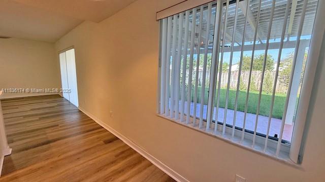 628 Turtle Run, Weston, FL 33326 - hall featuring wood finished floors and vaulted ceiling