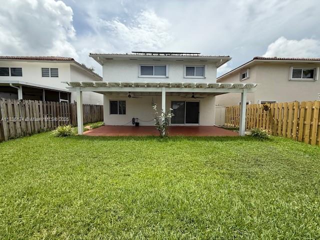 628 Turtle Run, Weston, FL 33326 - back of property with a ceiling fan, a patio area, a pergola, and stucco siding