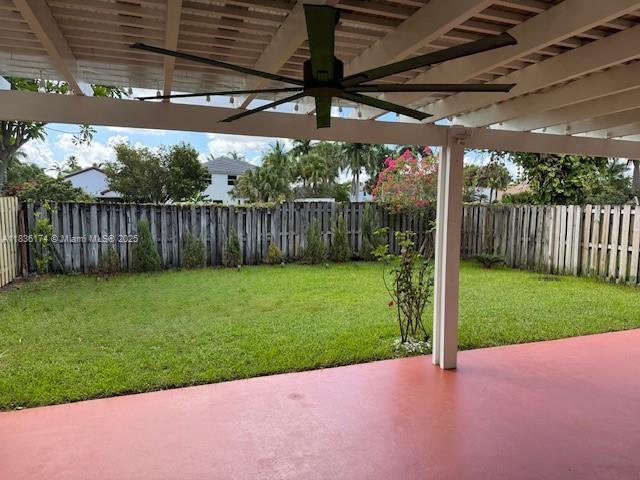 628 Turtle Run, Weston, FL 33326 - fenced backyard with ceiling fan and a patio