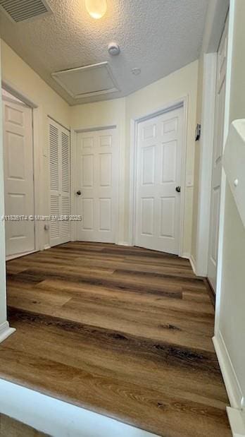 628 Turtle Run, Weston, FL 33326 - hall with wood finished floors, attic access, and a textured ceiling