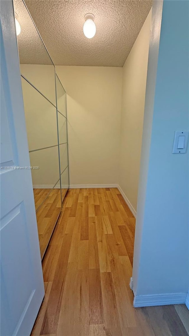 628 Turtle Run, Weston, FL 33326 - hallway with wood finished floors and a textured ceiling