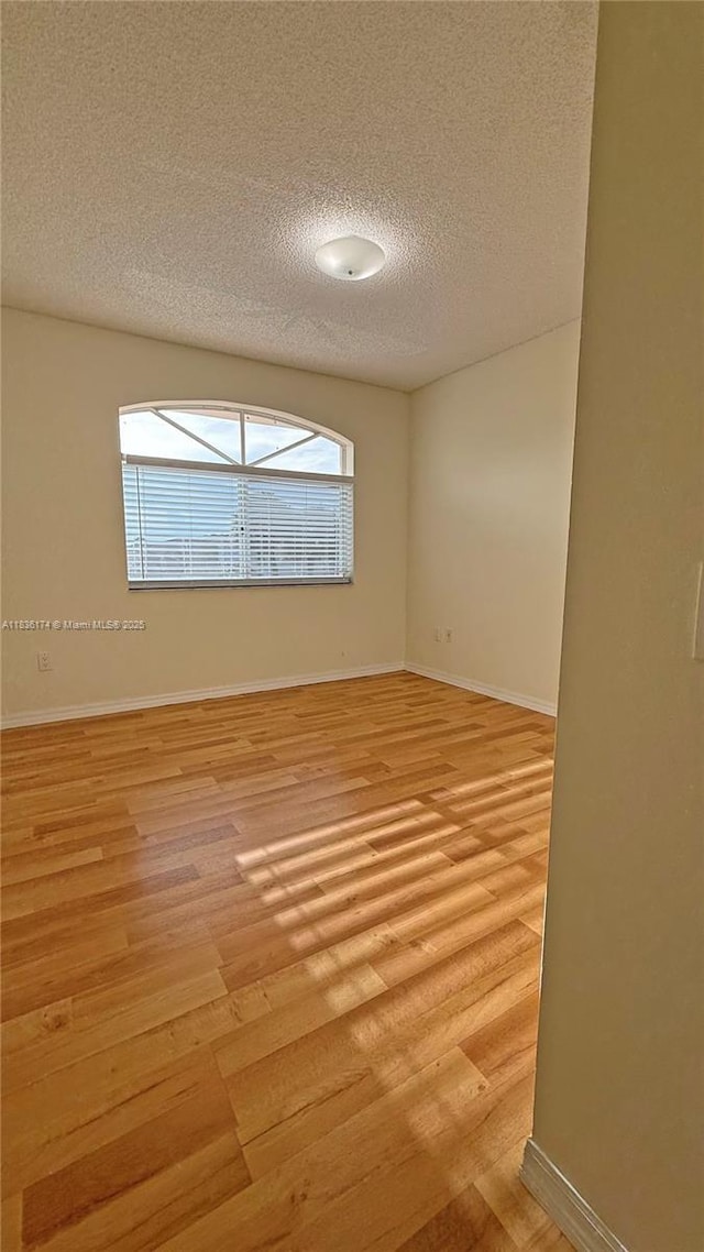 628 Turtle Run, Weston, FL 33326 - empty room featuring a textured ceiling and light wood-style floors