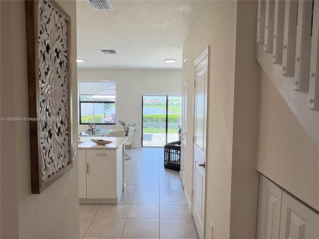 3482 114th Ter, Hialeah, FL 33018 - hallway featuring light tile patterned floors and a textured ceiling
