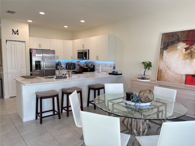 3482 114th Ter, Hialeah, FL 33018 - dining area with light tile patterned floors and recessed lighting