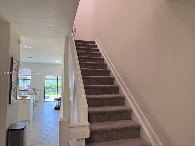 3482 114th Ter, Hialeah, FL 33018 - stairs with tile patterned floors and a textured ceiling